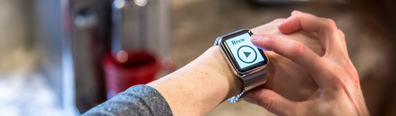 Smart Watch for Connected Home Person brewing copy from smart watch in a connected home